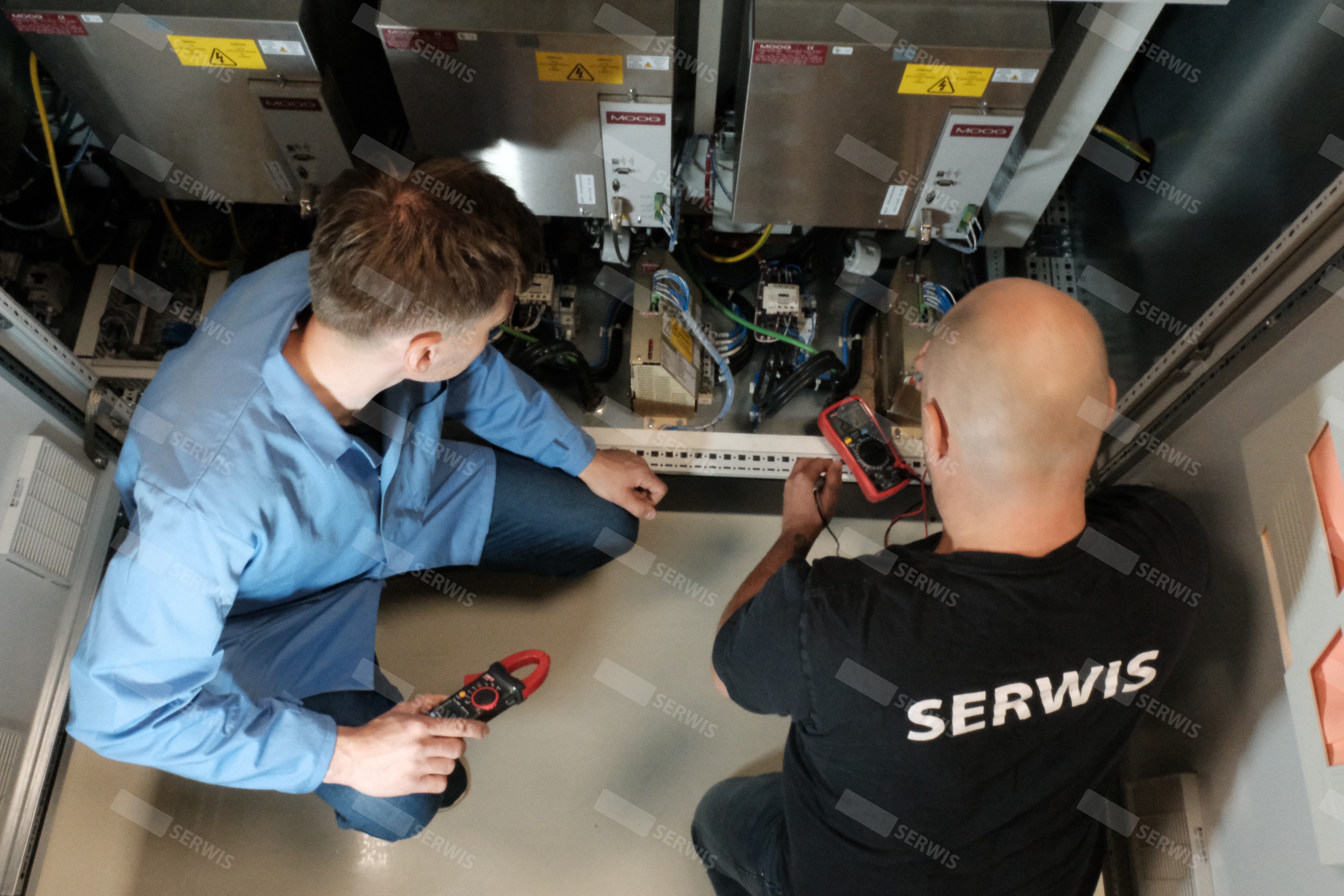 Technicy serwisowi diagnozujący sprzęt elektroniczny w serwerowni